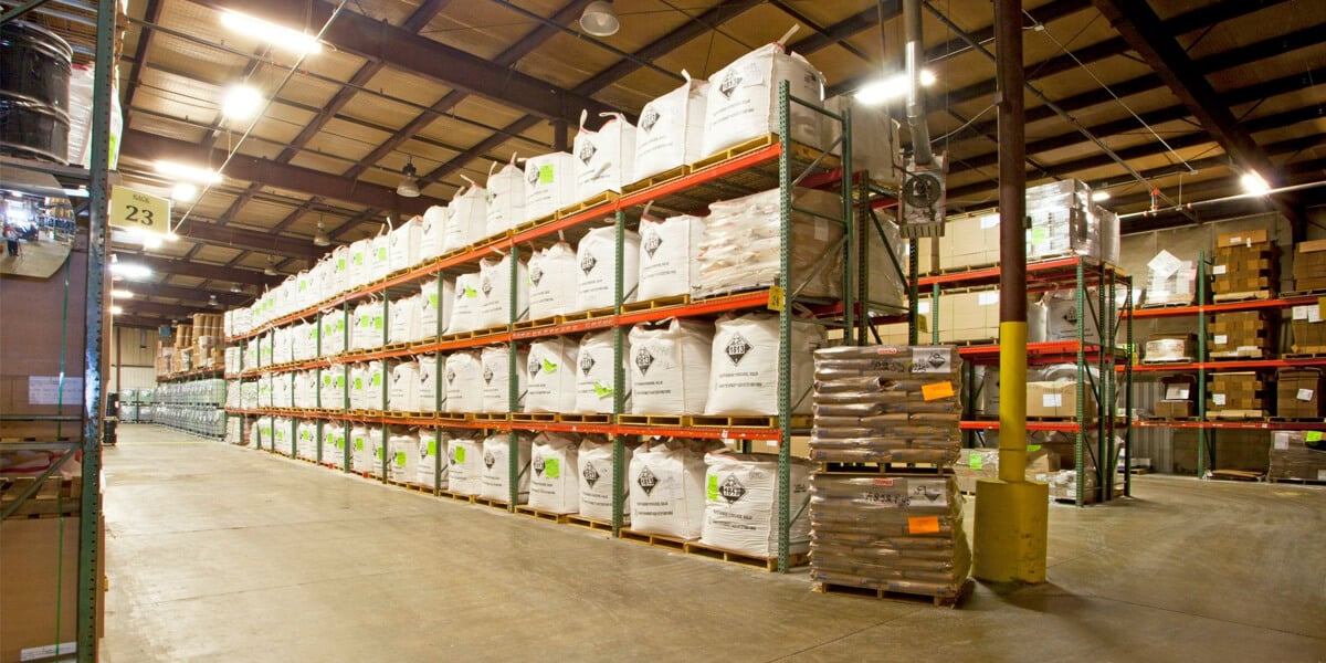 Bulk chemicals packaged and shelved in a warehouse, ready for transport